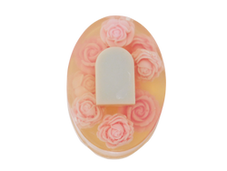 Oval shaped soap with tombstone and rose design. Roses are pink and tombstone is grey. 