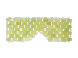green and white eye mask in the shape of glasses with circular pearls surrounding the outside edge. 