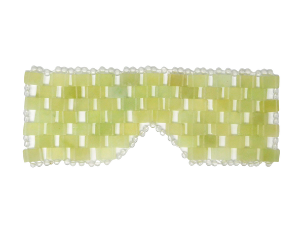 green and white eye mask in the shape of glasses with circular pearls surrounding the outside edge. 