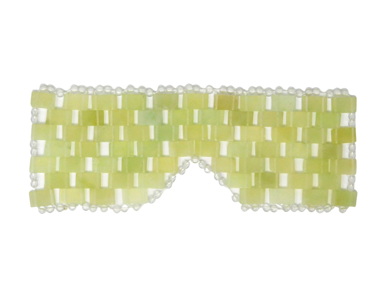 green and white eye mask in the shape of glasses with circular pearls surrounding the outside edge. 