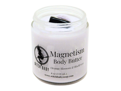 4 oz glass jar filled with light purple body butter  topped with magnetic hematite. Clear label reads: Magnetism Body Butter. Orange Blossom & Blackberry.