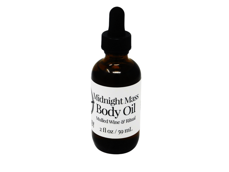A 2 oz glass dropper bottle of Midnight Mass Body Oil with a black label and dropper, set against a black background.