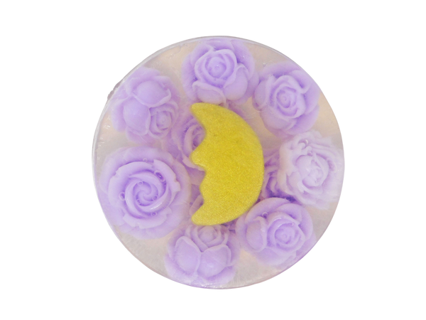 circular clear soap packed with violet colored roses and a golden crescent moon