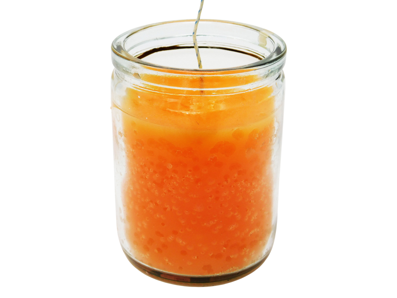 orange candle in glass jar