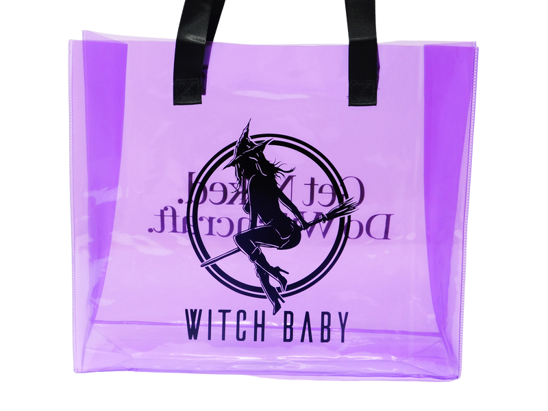 witch baby logo on one side of purple translucent tote bag with black handles
