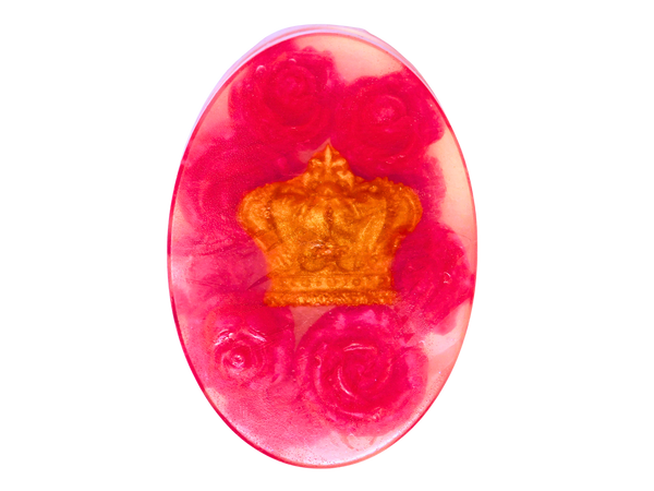 clear oval soap with a gold crown at the center surrounded by hot pink roses