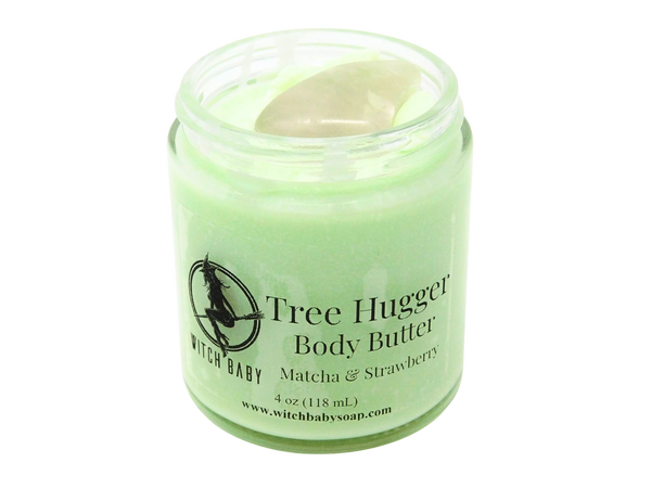 4 oz glass jar filled with green body butter and topped with a rose quartz. Label reads: Tree Hugger Body Butter. Matcha & Strawberry. 